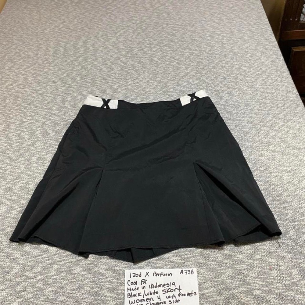Izod X Performance black golf skirt with white X-shaped straps size 4. SKU-A738